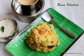 Ravva Kichidi:<br />How to make Rava Khichdi/Kichadi<br /><br />Prep time - under 15 mins<br />Cook time - under 20 mins<br />Serves - 2<br /><br />Ingredients needed <br /><br />Rava/Sooji/Semolina -1 cup <br />Onion - 3/4 cup finely chopped<br />Ginger - 1 tsp finely chopped <br />Green chillies -2 slit<br />Vegetables - 3/4 cup ( mix of beans, carrot, peas and 1/2 a tomato)<br />Turmeric powder - 1/4 tsp<br />Water - 3 cups<br />For topping up - 1 tsp ghee<br />For roasting - 1 tsp ghee<br /><br />For the seasoning <br /><br />Oil - 2 tbsp + Ghee - 1 tbsp<br />Mustard seeds - 1 tsp <br />Bengal gram/ kadalai paruppu- 2 tsp <br />Urad dal -1 tsp <br />Curry leaves - few <br /><br />Rava Khichdi preparation<br /><br />Roast rava in a tsp of ghee until you get a nice aroma of roasted rava. Skip this step if you have bought roasted rava.<br /><br />Chop all the vegetables finely. Slit green chillies and keep it ready.<br /><br />Method<br /><br />Heat ghee+oil in a pan/kadai, add bengal gram, when it changes colour slightly, add mustard seeds, urad dal and curry leaves.<br /><br />When urad dal turns golden brown, add finely chopped onions, slit chillies and ginger.<br /><br />Saute until onions turn transparent. Then add all the finely chopped vegetables and turmeric powder. Look how colorful it is.(picture below)<br /><br />Saute and cook the vegetables for 2-3 minutes. Do not over cook the vegetables as it will get cooked along with the rava.<br /><br />Now add 3 cups of hot water and salt needed. You can taste the water and check for salt. If it is slightly salty, it will be perfect after adding rava.