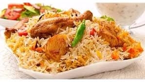 MALABAR CHICKEN BIRYANI<br /><br />Malabar Chicken Biriyani is a non vegetarian rice variety. This delicacy from the Malabar region of Kerala is very popular among Biriyani lovers.<br /><br />Ingredients<br />Basmathi rice - 1 kg<br />Chicken - 1<br />Biriyani Masala Paste<br />(green chilly, cinnamon, cloves, fennel, cardamom, peppercorn) - 4tbsp<br />Green chilly - 10<br />Ginger garlic paste - 2 tbsp<br />Coriander leaves - 50 g<br />Mint leaves - 25 g<br />Curd - 150 ml<br />Tomato - 150 g<br />Onion - 1 kg<br />Black cumin seeds - 1 tsp<br />Cinnamon stick - 2 pieces<br />Bay leaves - 2<br />Cashew nuts kismis - 50 g<br />Cardamom - 5<br />Ghee - 200 g<br />Coriander powder - 2 tbsp<br />Milk - 500 ml<br />Saffron - 1 pinch<br />Water (For rice) - 1 litre<br /><br />Method of preparation<br />Heat the ghee in a saucepan; saute the onions till golden brown colour and add sliced tomatoes saute well. Put ginger garlic paste, curd and biriyani masala and turmeric powder, and coriander powder. Add the chicken pieces and cook well. Soak the rice about 10 minutes and drain well. Melt the ghee in a saucepan and add in the spices and sliced onion mint, coriander leaves, cashew nuts, kismis, bay leaves and saute till brown in colour. Add milk and water. Allow to boil and then add rice. Lower the heat, cover and continue to cook for 15 minutes. Take another saucepan and place half the rice into it. And add the chicken on the top of the rice. And put the remaining rice on top of the chicken. And spread to make an even layer. Make random holes through the rice with a spoon and pour into each a little saffron milk. Place a few knobs of ghee, fried onion, cashew nuts and kismis on the surface and cover tightly.